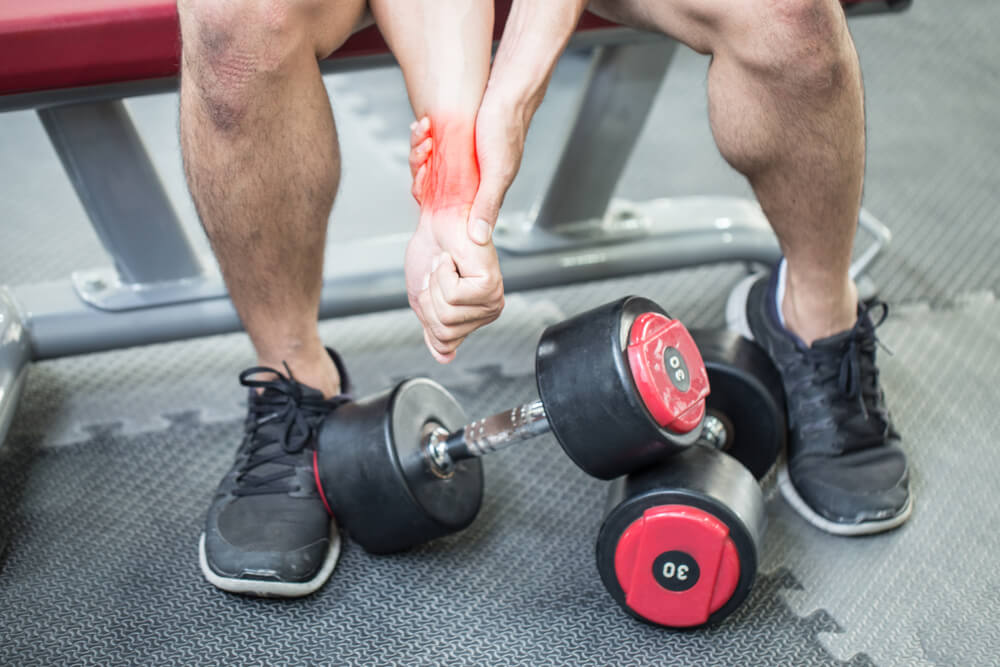 What causes wrist pain from lifting? shutterstock 1022238508 wrist pain from lifting