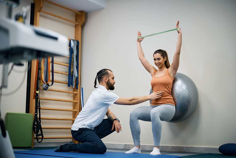Personal trainers vs. physical therapists: 6 key differences physiotherapist assisting young sportswoman with e 2023 11 27 05 35 48 utc 1 Personal trainers vs. physical therapists: 6 key differences