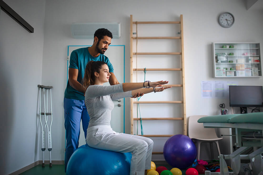 Top 7 interview questions every physical therapy aide should be prepared for young male physiotherapist exercising with young w 2023 11 27 04 53 15 utc Top 7 interview questions every physical therapy aide should be prepared for